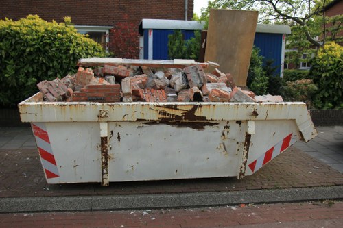 Collection truck picking up old furniture from residential area
