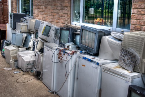 Professionals handling large furniture items for disposal