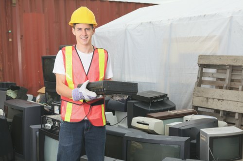 Professionals sorting furniture materials for disposal